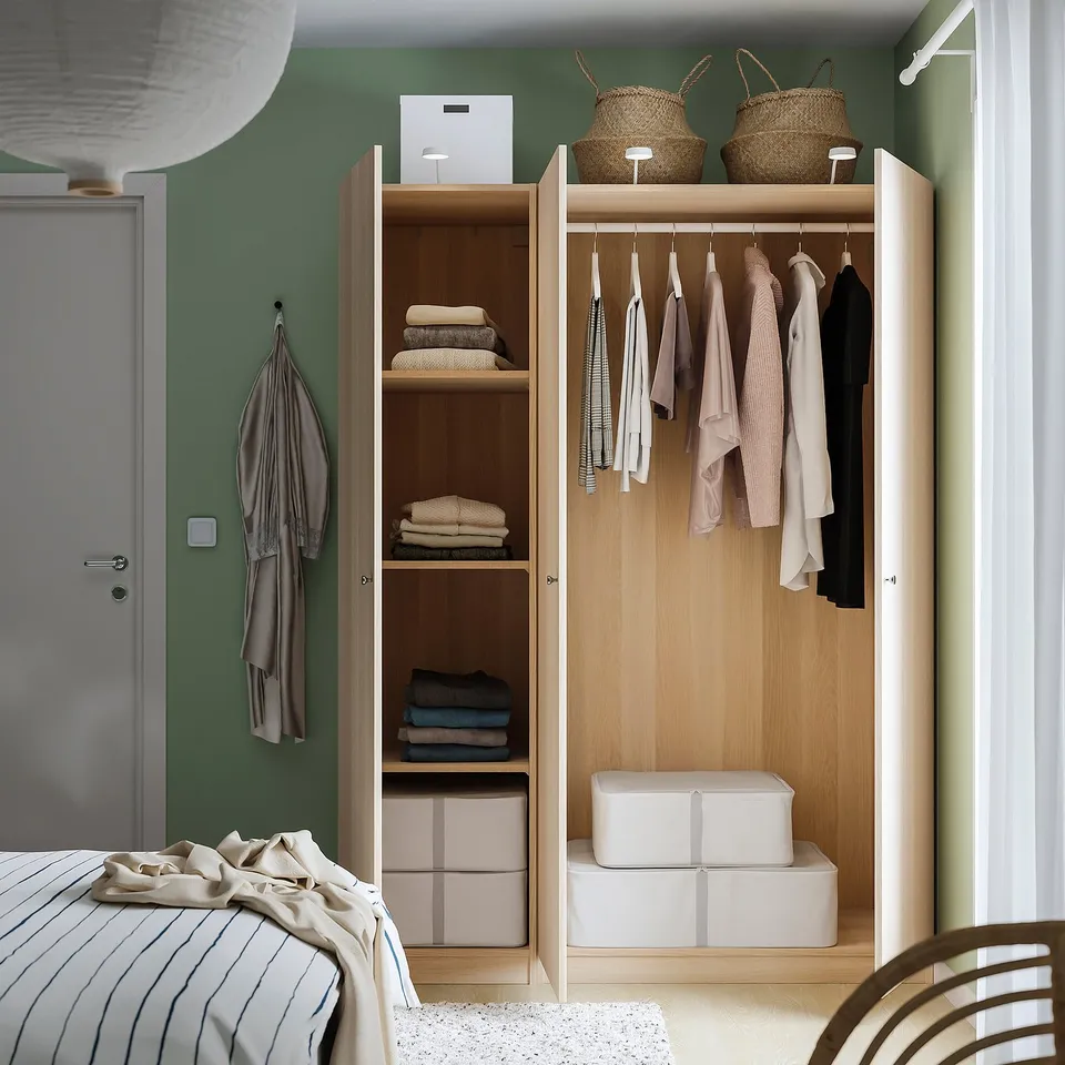 Modern closet with mirror doors reveals clothes and storage, featuring lighting and adjustable shelves.