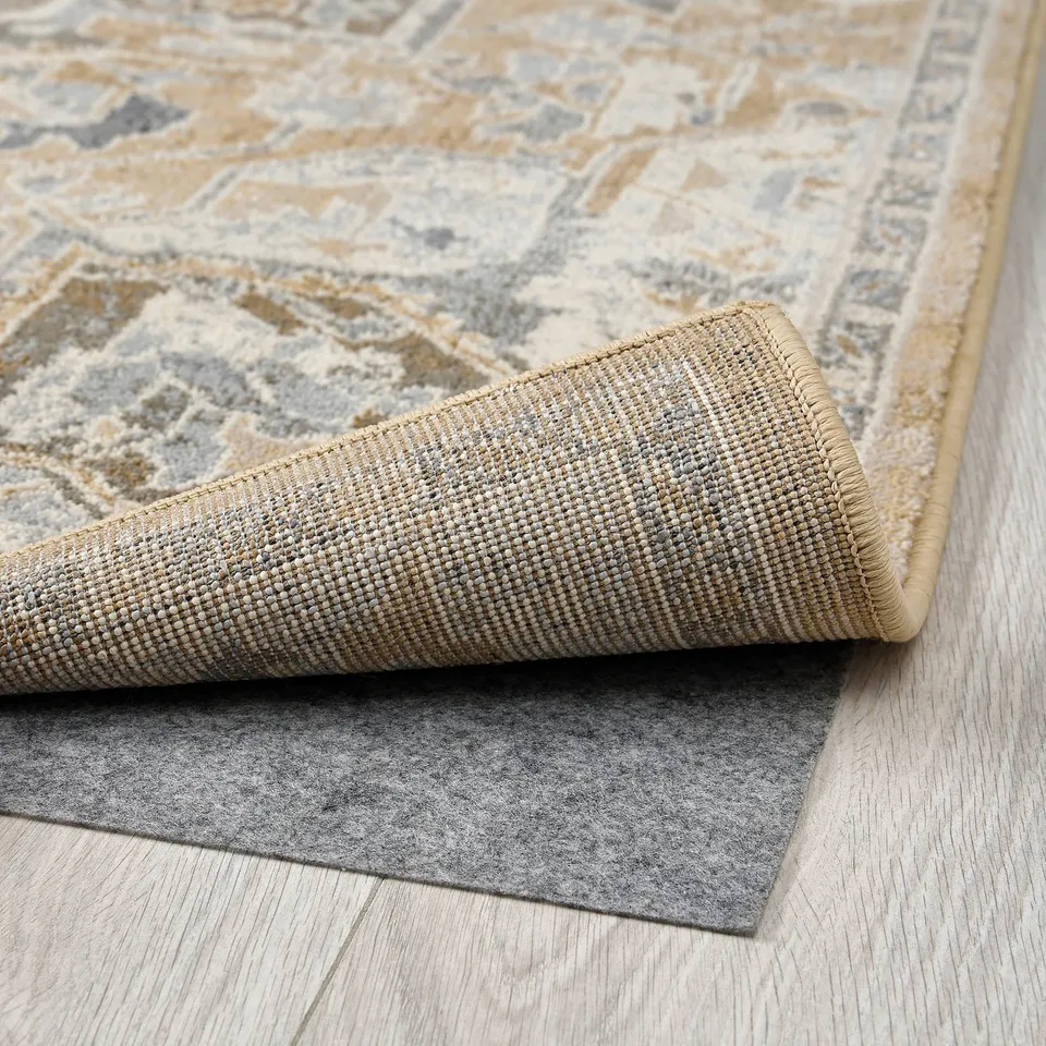 A rolled light-patterned rug with a textured backing, showcasing its durable and quality material.