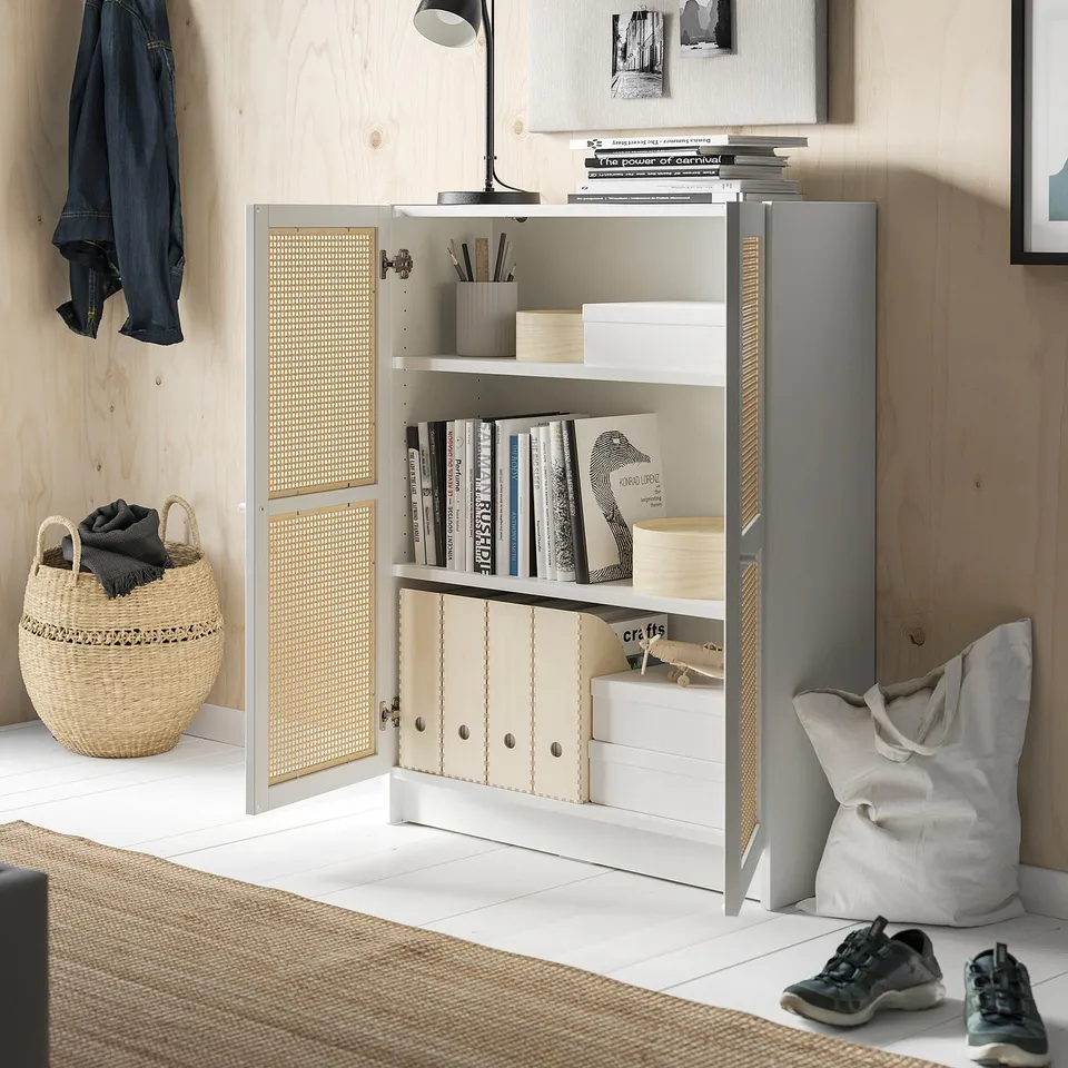 Modern bookcase with bamboo doors, light wood finish, storing books, crafts, and office supplies in a clean, minimalist room.