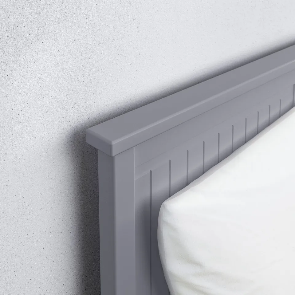 Modern light grey daybed, neatly aligned against a plain wall. Sturdy frame with smooth edges, clean design.