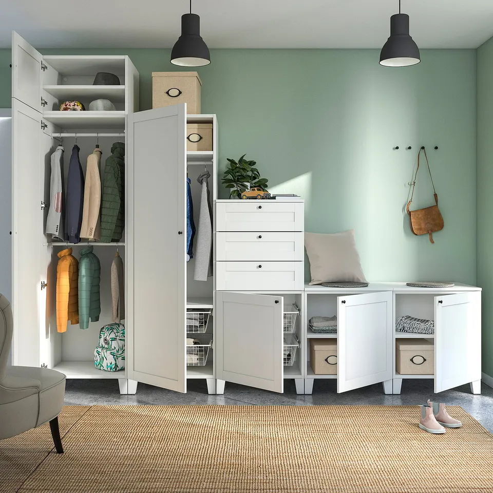 Modern closet with open door, storage unit, rug, lights, plant, and purse on hooks.