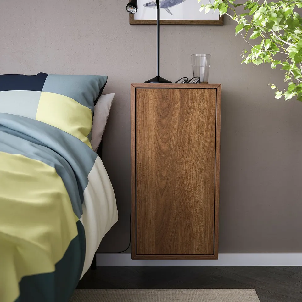 Modern bedroom with EKET wooden bedside table, light wood finish, rectangular shape, floating above bed. Simple, minimalist design.