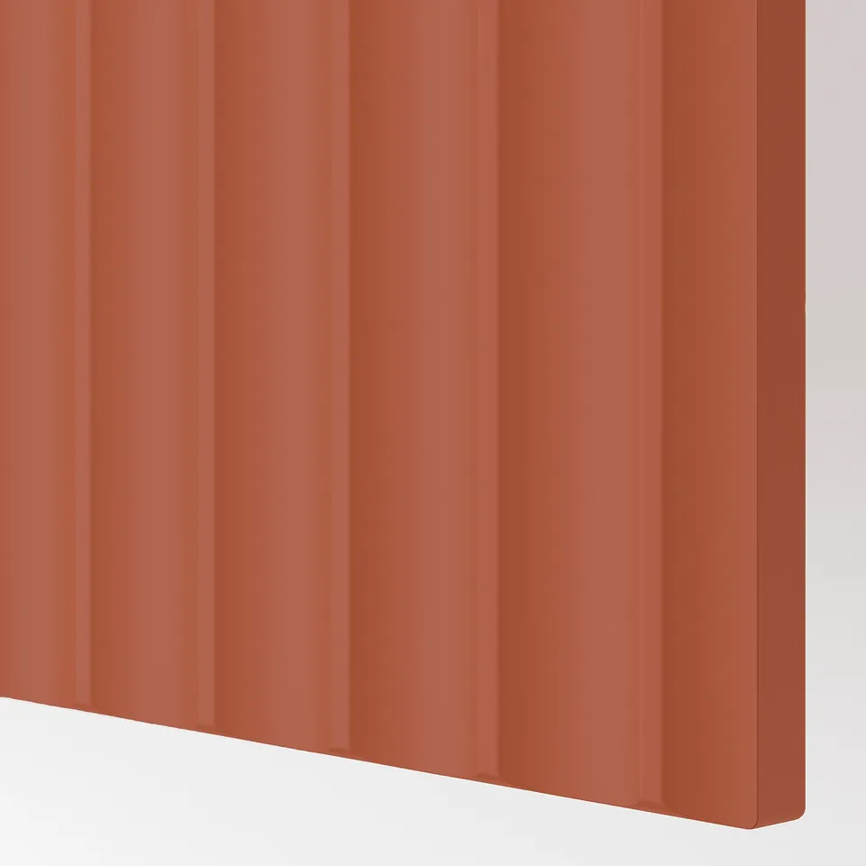 Close-up of a red-brown cover panel with a wavy texture, showcasing smooth surface and vibrant colour.