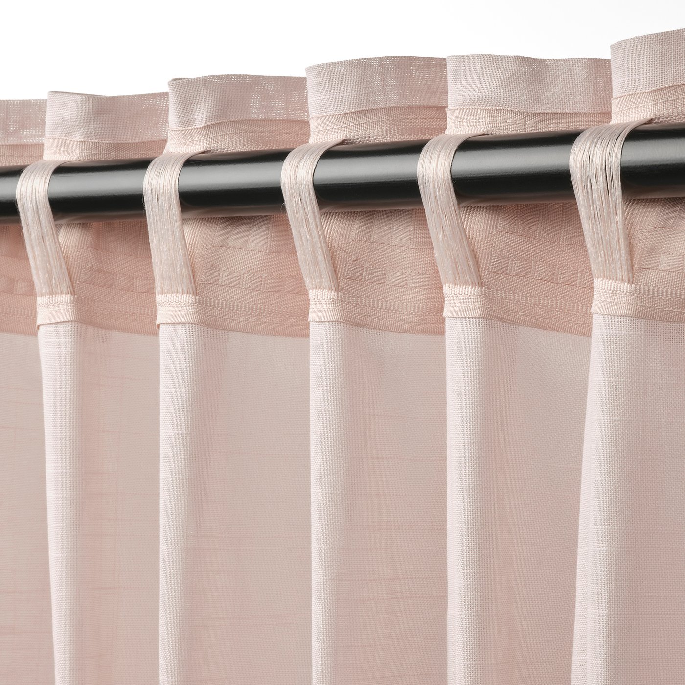 Pink SILVERLÖNN curtains with linen texture and sheer fabric diffusion.
