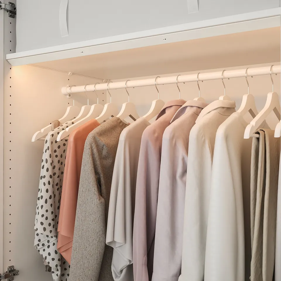 Closet with led light on clothes.
