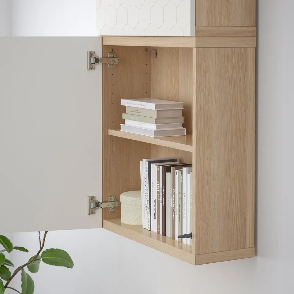 Lightwood cabinet with open doors displaying books. Wall-mounted, part of BESTÅ series.