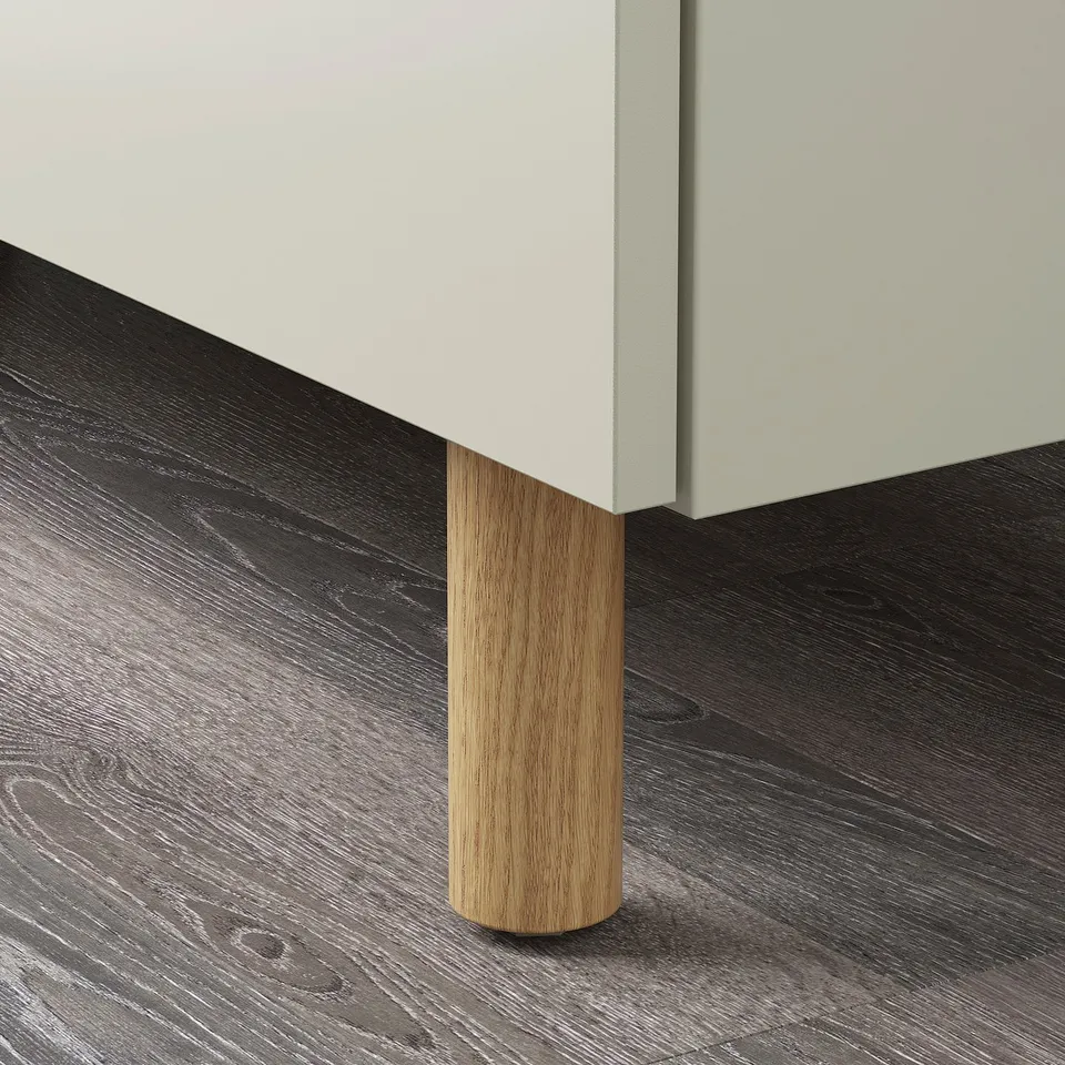 Modern cabinet with sleek lines and wooden leg, showcasing quality craftsmanship.