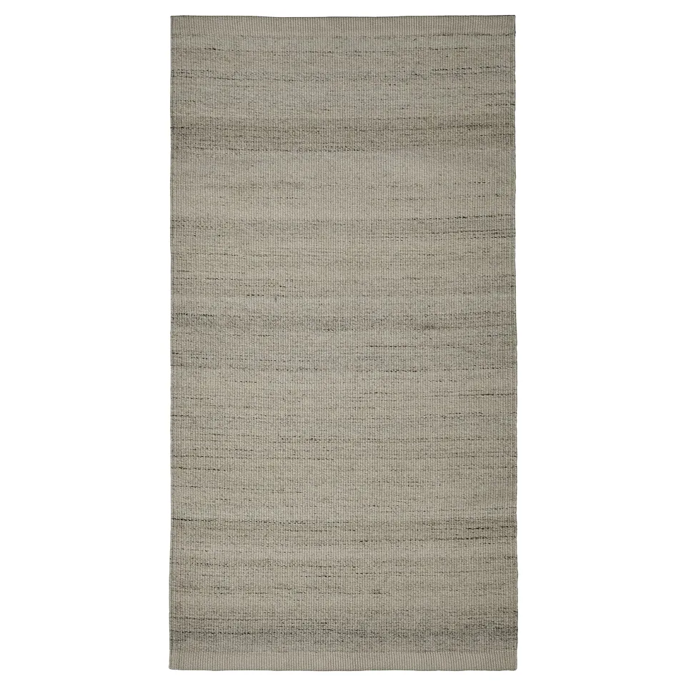 Flatwoven grey rug, rectangular shape, subtle striped design, made of cotton and wool.