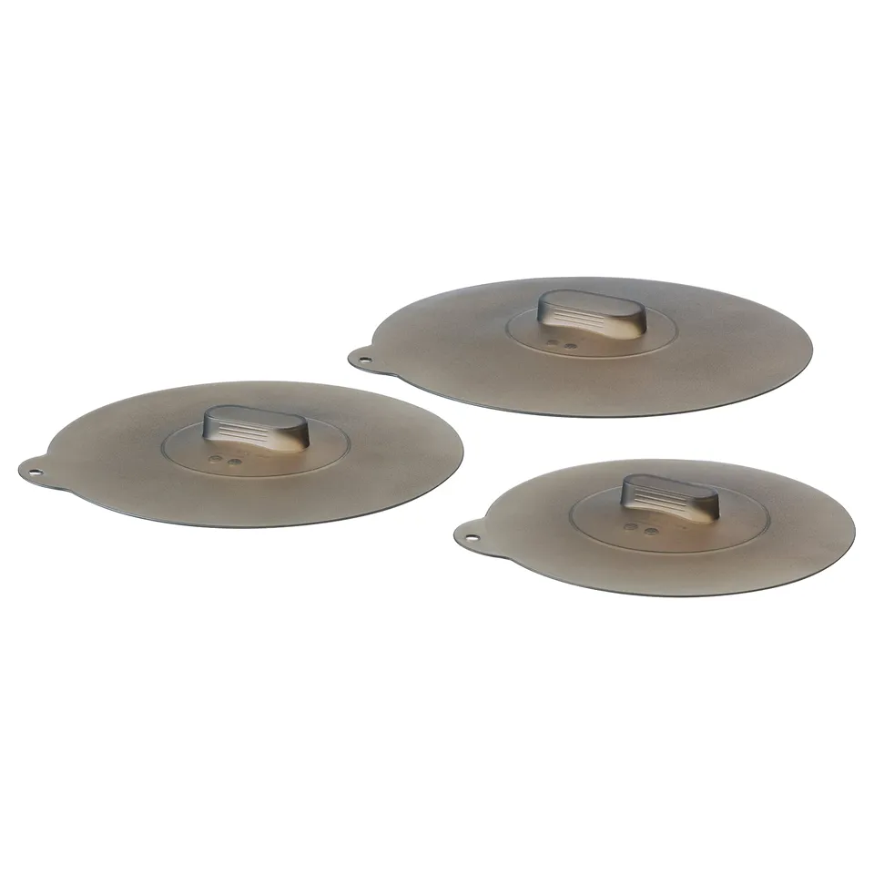 Three grey vacuum silicone lids, circular with handles, arranged in a triangle on a white background.