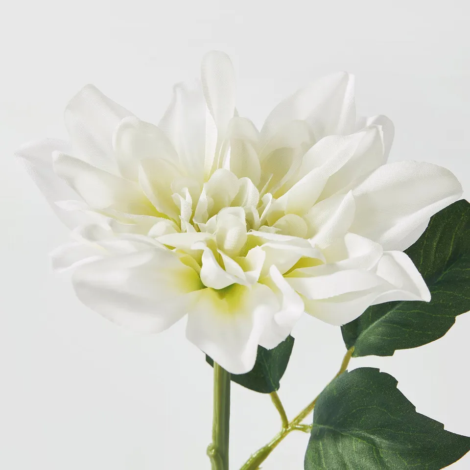 White artificial dahlia with green leaves; vibrant, lifelike detail; quality craftsmanship visible.