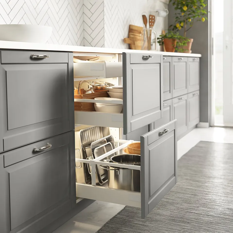 Modern kitchen drawers with led lights, organised utensils and pots.