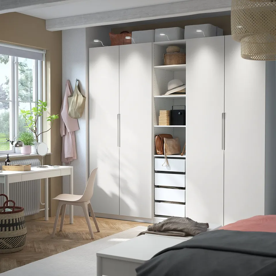 Modern bedroom with white PAX wardrobe & hanging chair.