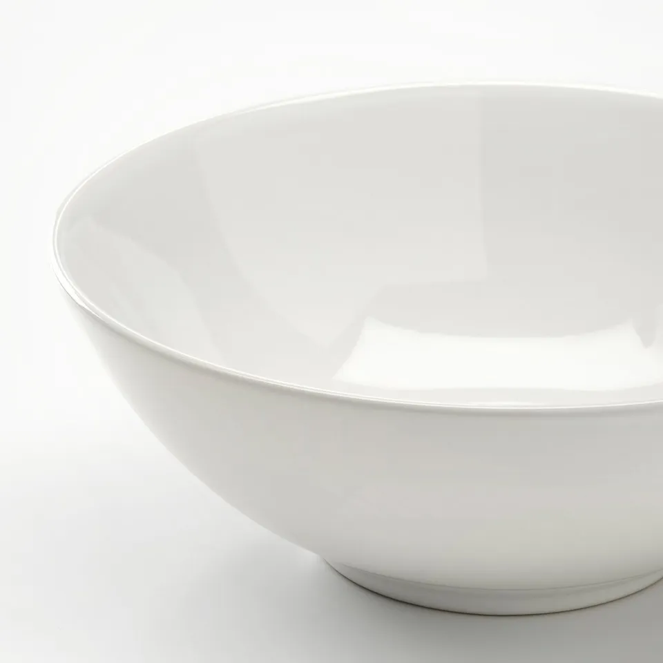 Large white bowl, glossy, reflects light.