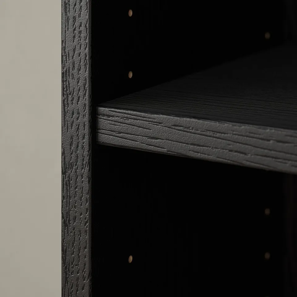 Dark wooden bookshelf with textured edges. Empty shelves ready for storage.