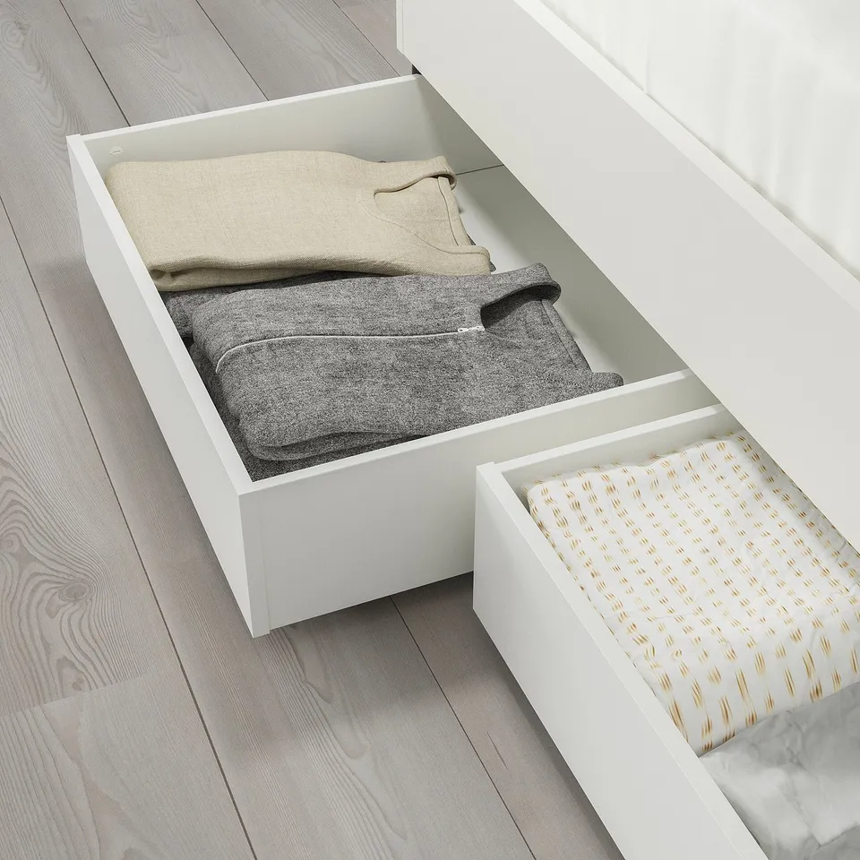 Two open storage boxes under bed for bedding, easy to access with castors.