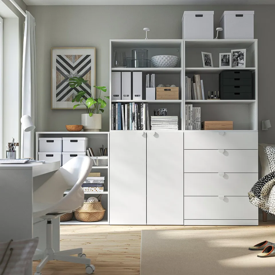 Home office with LASTARE bookshelf and cabinet, modern chair, neat desk, minimalist style.