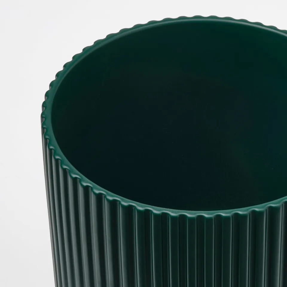 Dark green textured pottery planter with vertical grooves, smooth and sturdy earthenware finish.