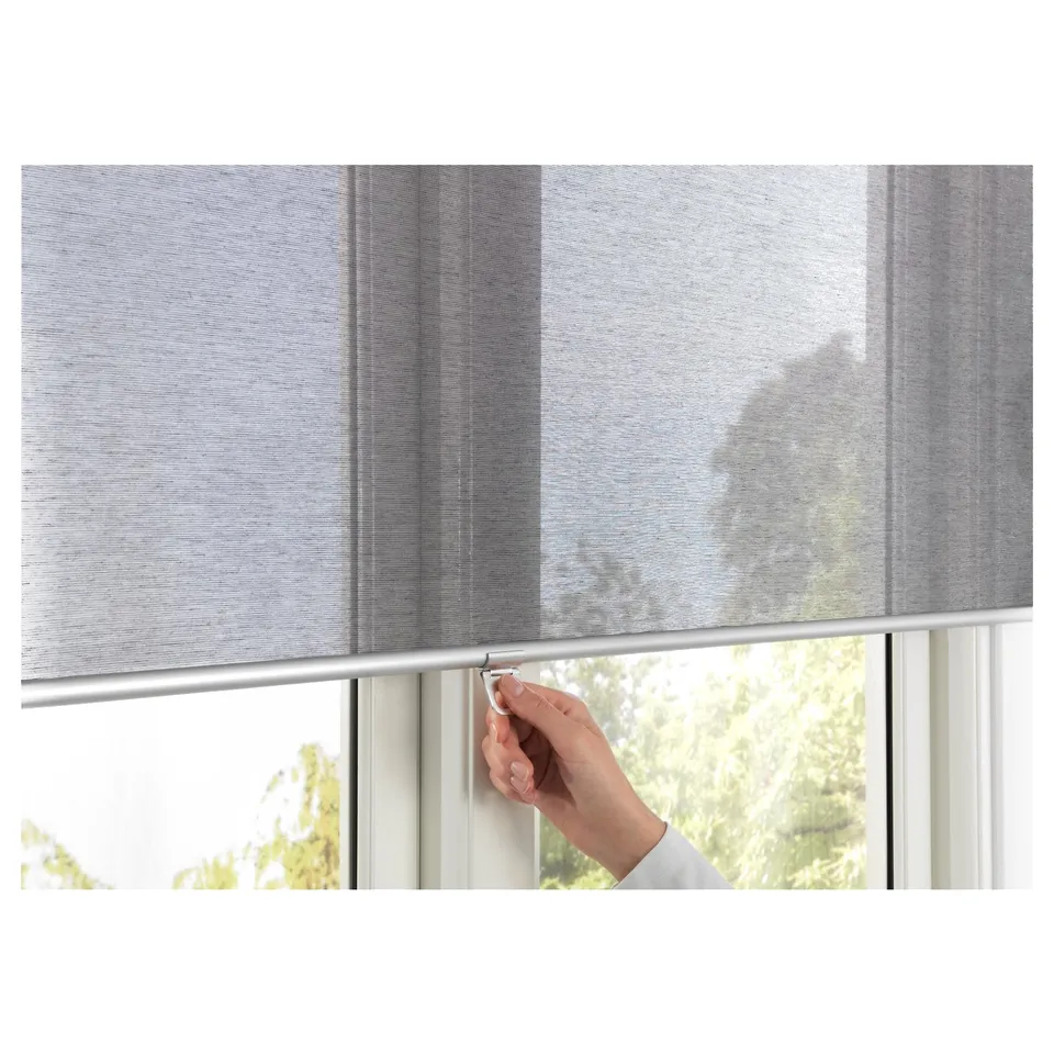Hand raising cordless roller blind with patterned fabric for child safety and soft close.