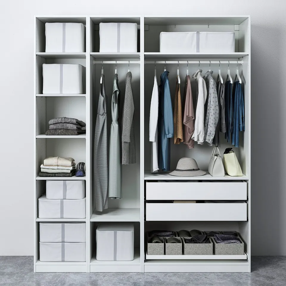 Modern closet with clothes, accessories, and storage boxes, featuring adjustable shelves and hangers.