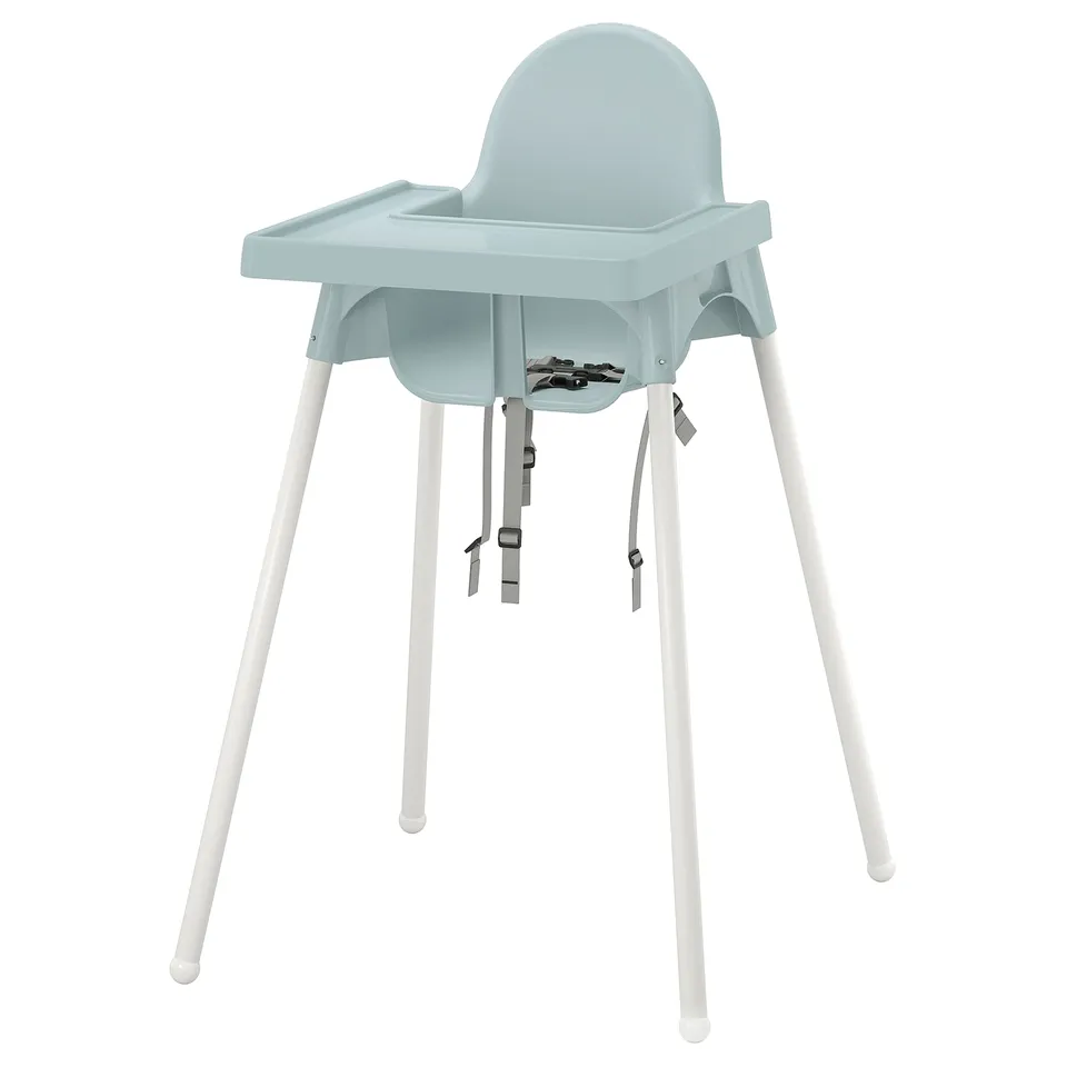 A light blue ikea ANTILOP high chair with white legs, featuring a tray and safety straps.