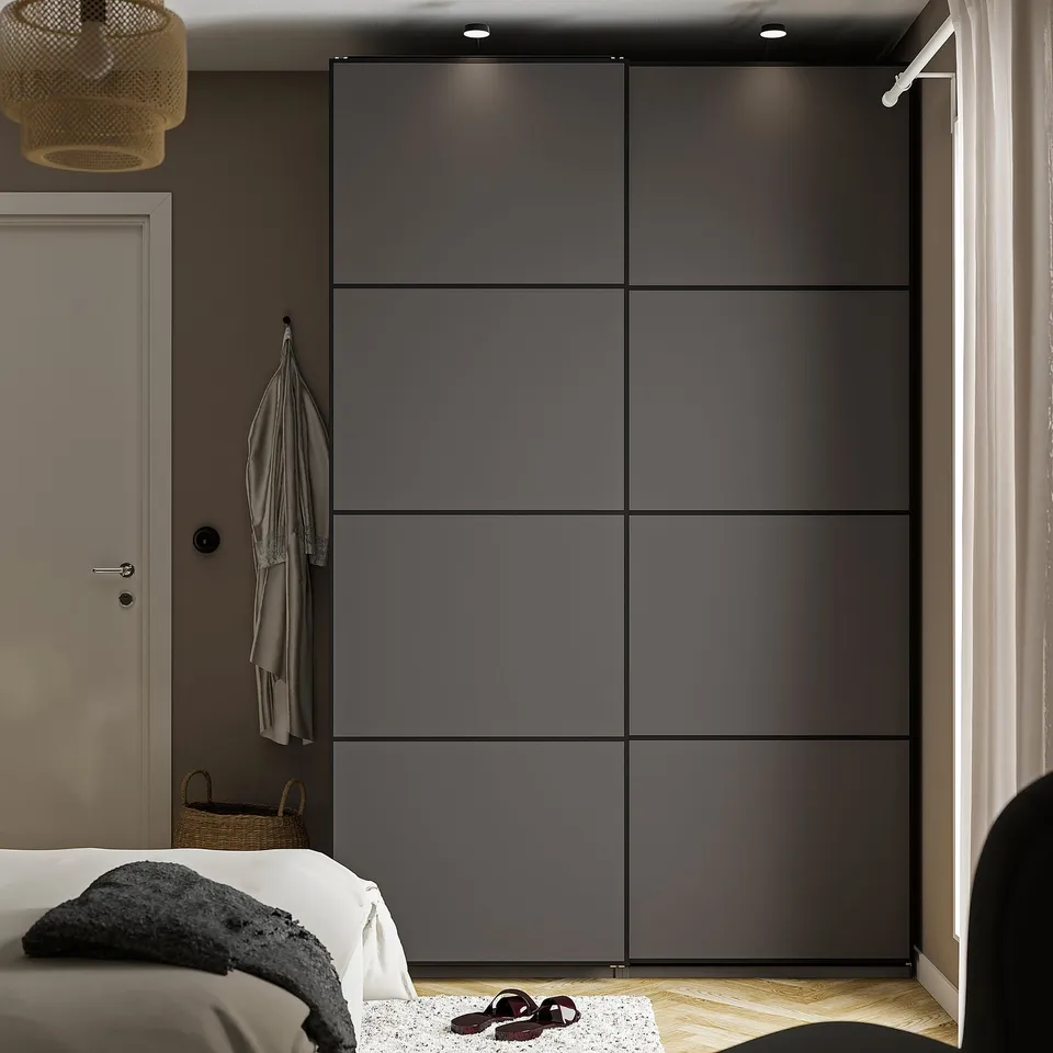 Modern bedroom with large PAX wardrobe, white bed, and decor.