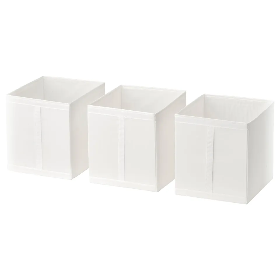 Three white SKUBB fabric storage boxes, rectangular, stackable, with zippered openings and handles for easy access and organisation.
