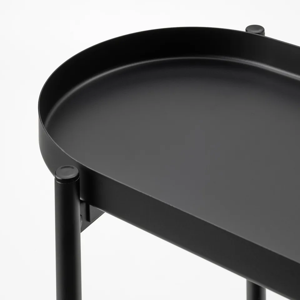 Black metal plant stand with round tray, sturdy & modern, ideal for indoor/outdoor plants.