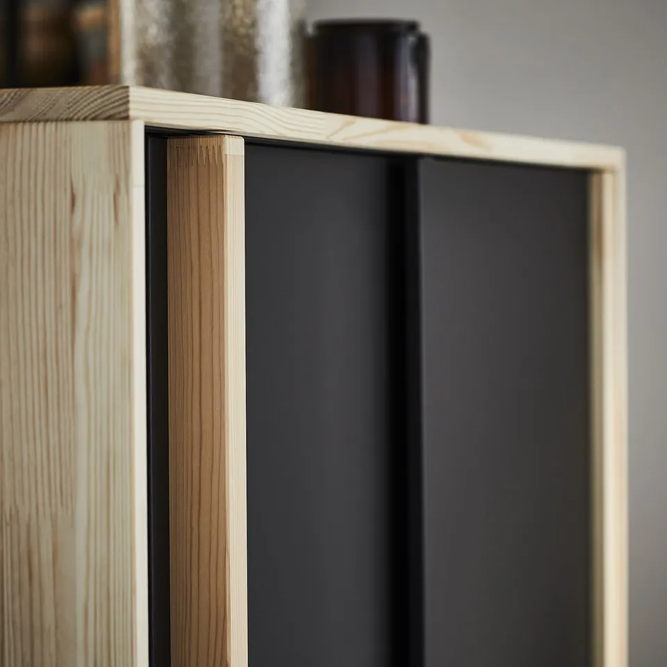 Modular wooden bookshelf with black interior, light brown wood grain. Moisture-resistant, minimalist design.