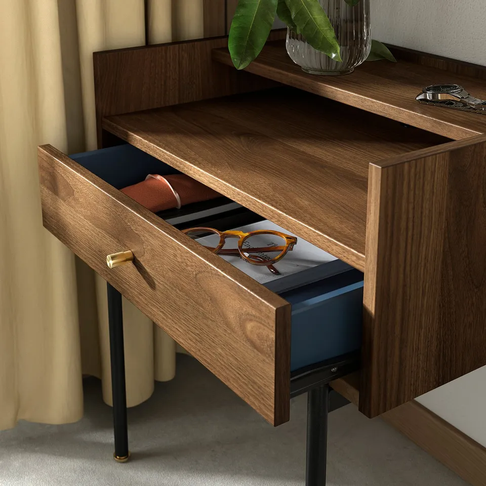 Wooden drawer open with sunglasses inside, on bedside table with dark legs.