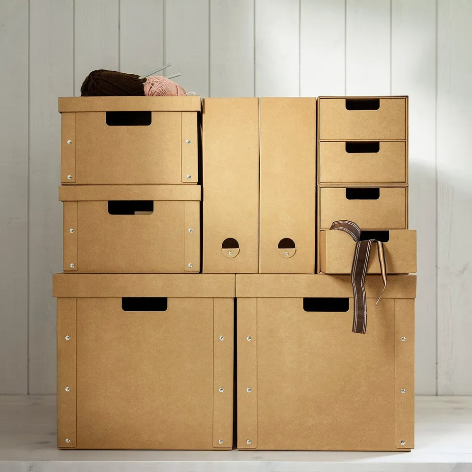 Brown cardboard storage boxes in various sizes, organised on shelves.