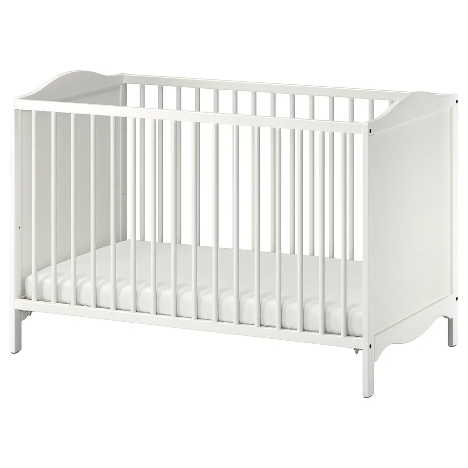 White wooden baby cot with simple design, safe edges, vertical slats, and mattress.
