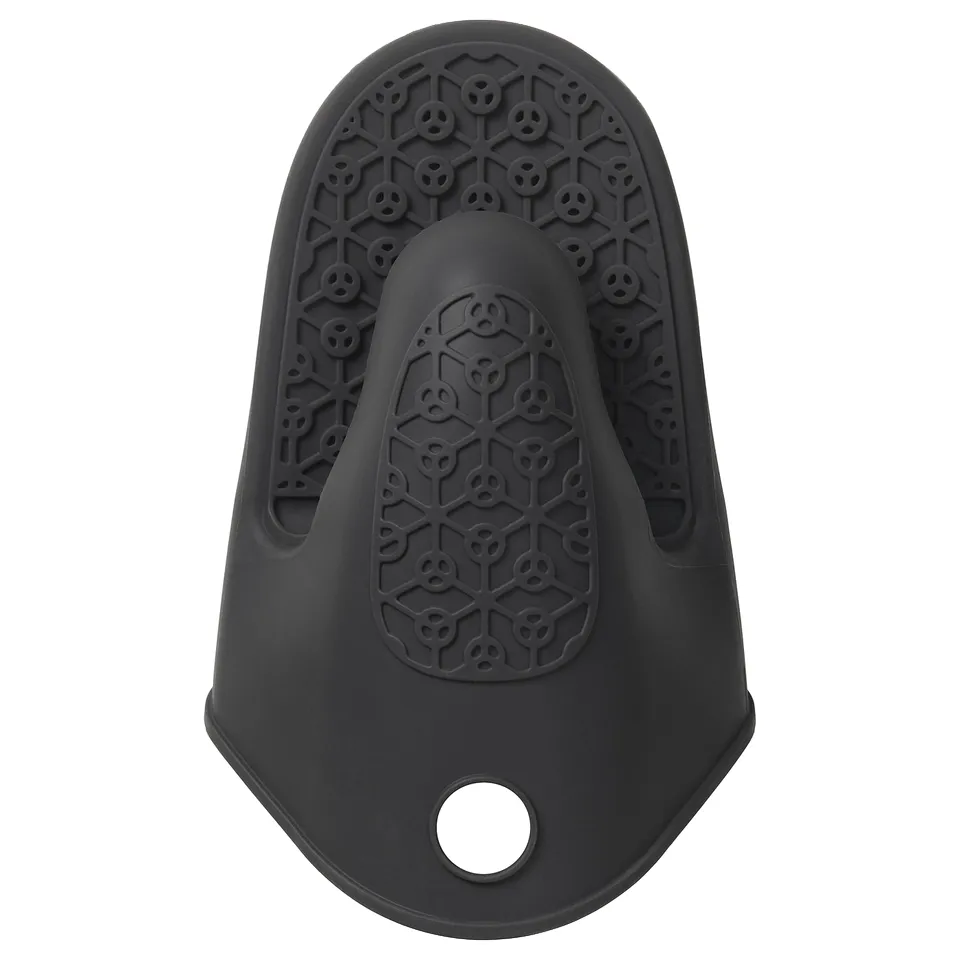Silicone oven mitt in dark grey, teardrop shape with skull pattern, designed for grip and heat protection.