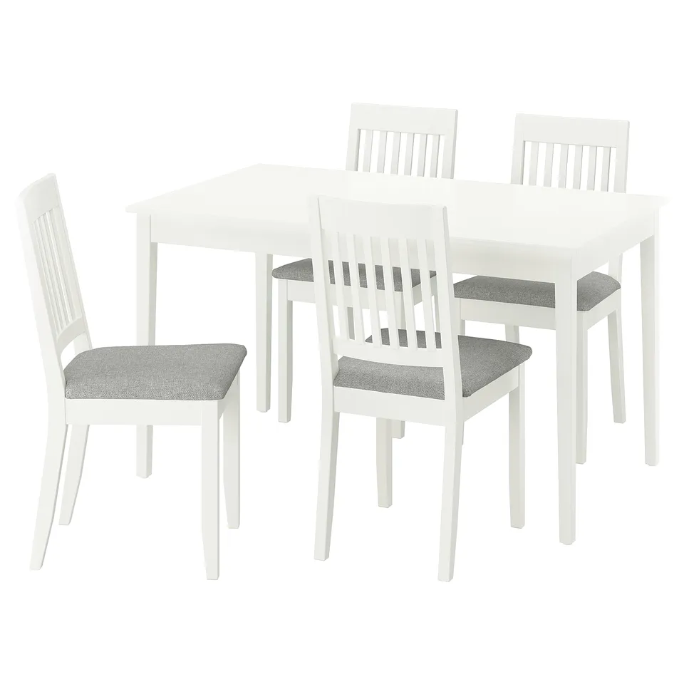 A white NÄSINGE dining set with a rectangular table and four matching chairs. The chairs have grey cushioned seats.