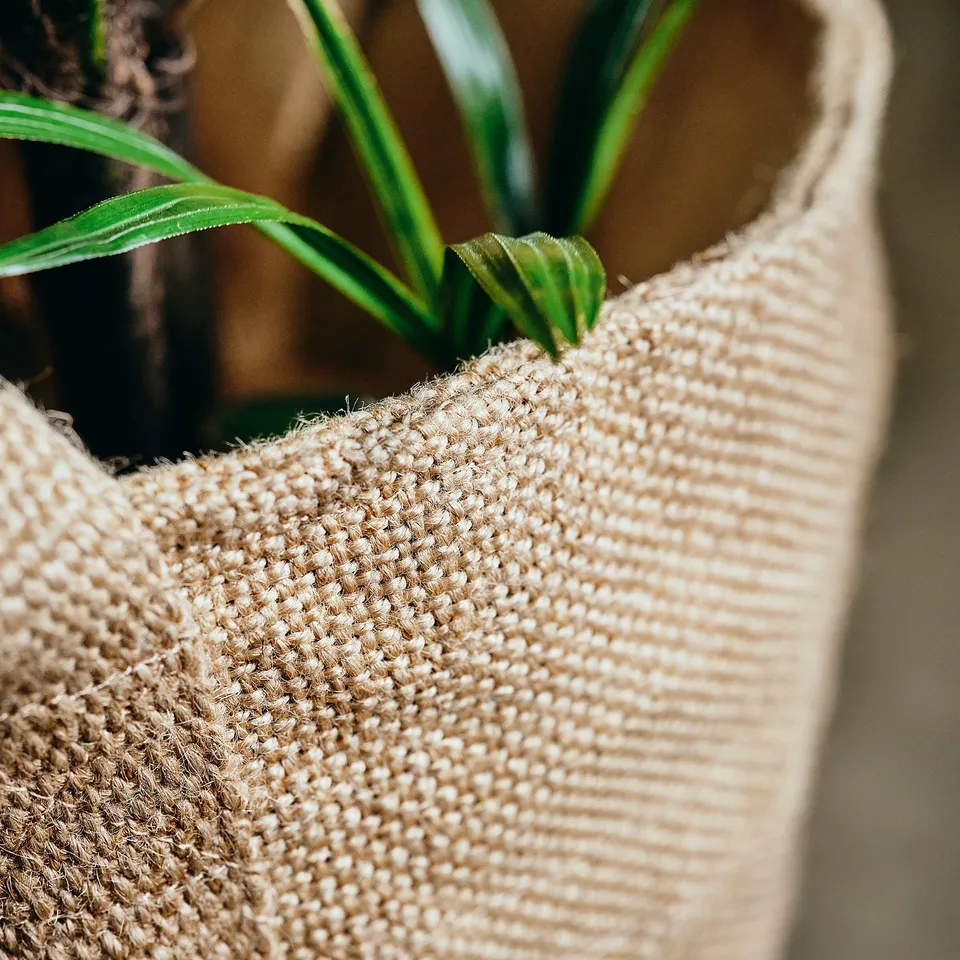Close-up of woven jute plant basket, showcasing texture and quality.