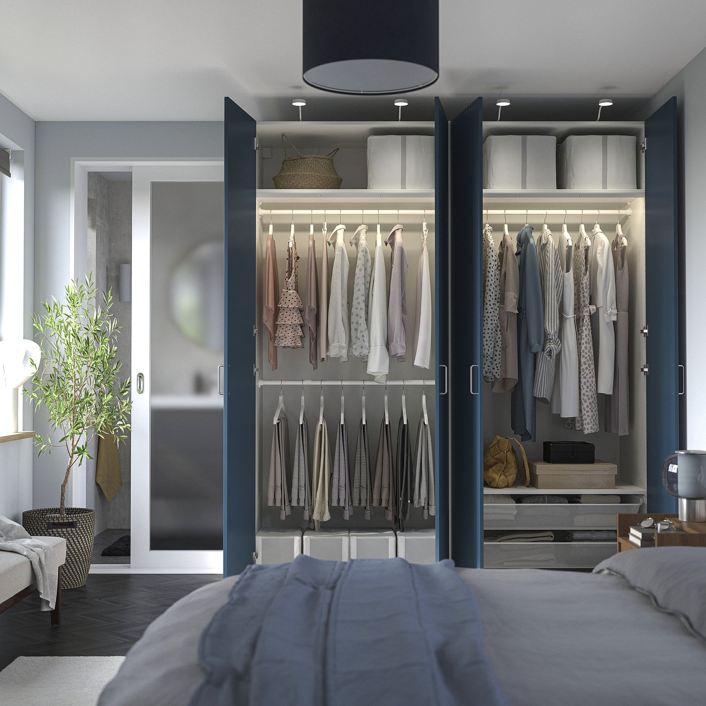 Modern walk-in closet with clothes, mirror, and plant.