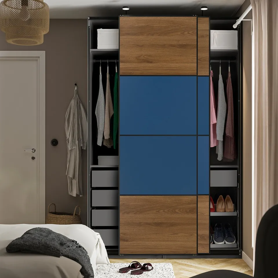 Modern wardrobe with sliding doors featuring hanging clothes, shelves, and shoe storage.
