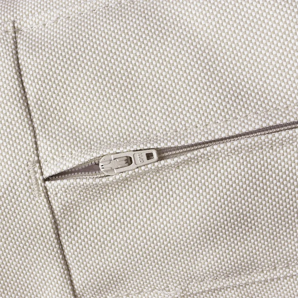 Close-up of durable beige fabric and quality zip on outdoor cushion
