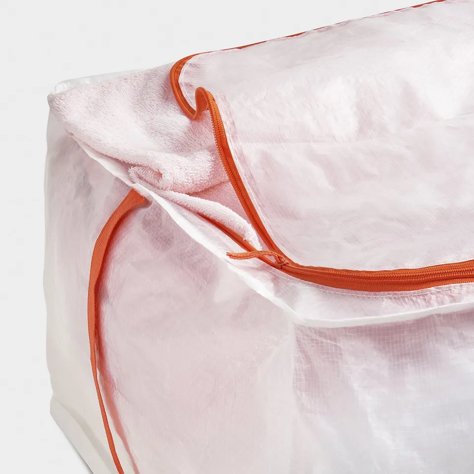 Large transparent storage bag with orange zip and handles.