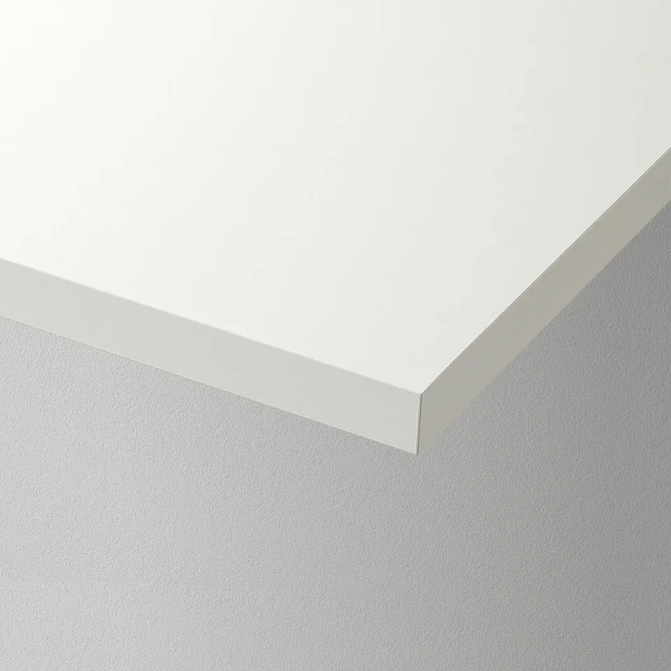 Crisp white wall shelf corner showcasing smooth, durable finish and clean edges.