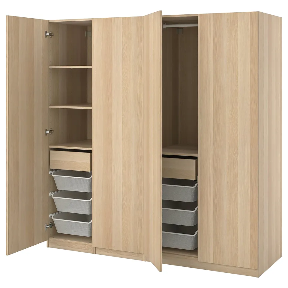 Light wood ikea PAX wardrobe with open drawers and shelves showing mesh baskets.