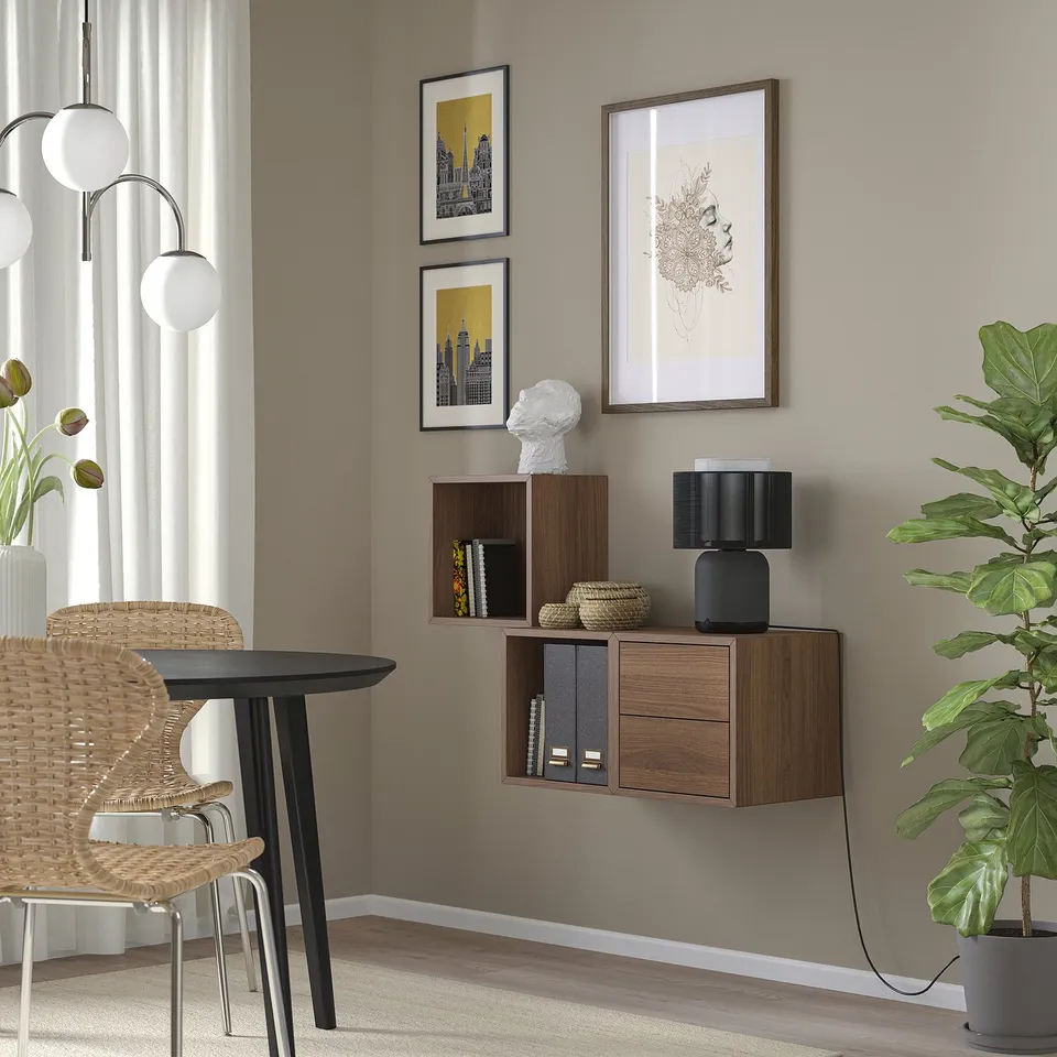 Modern living room with EKET shelves, art, and round table with globe light.
