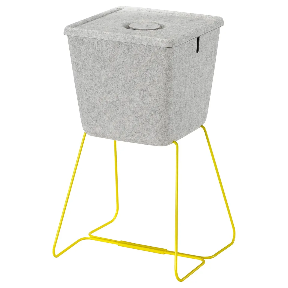 BRÄNNBOLL grey felt storage basket with yellow metal legs; square, modern design with carrying handles.