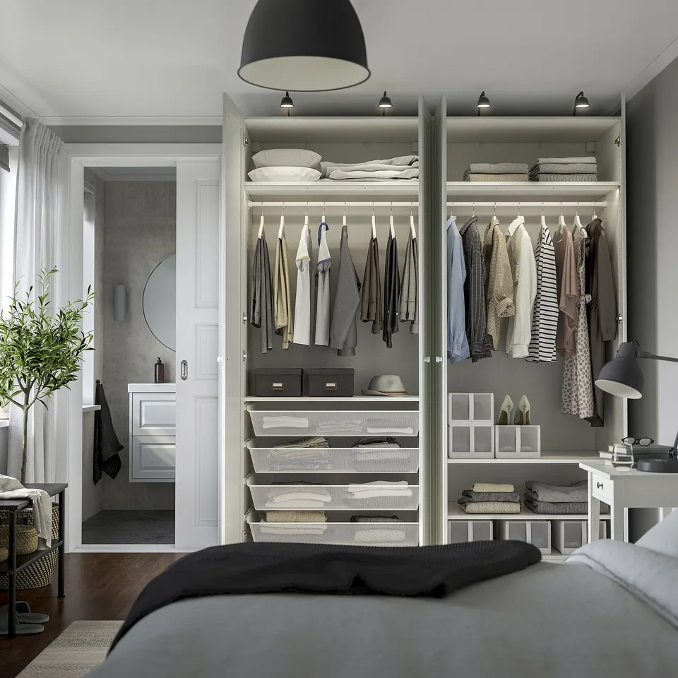 Bedroom with PAX wardrobe, organised clothes, shelves, and drawers, including hanging space and storage baskets.