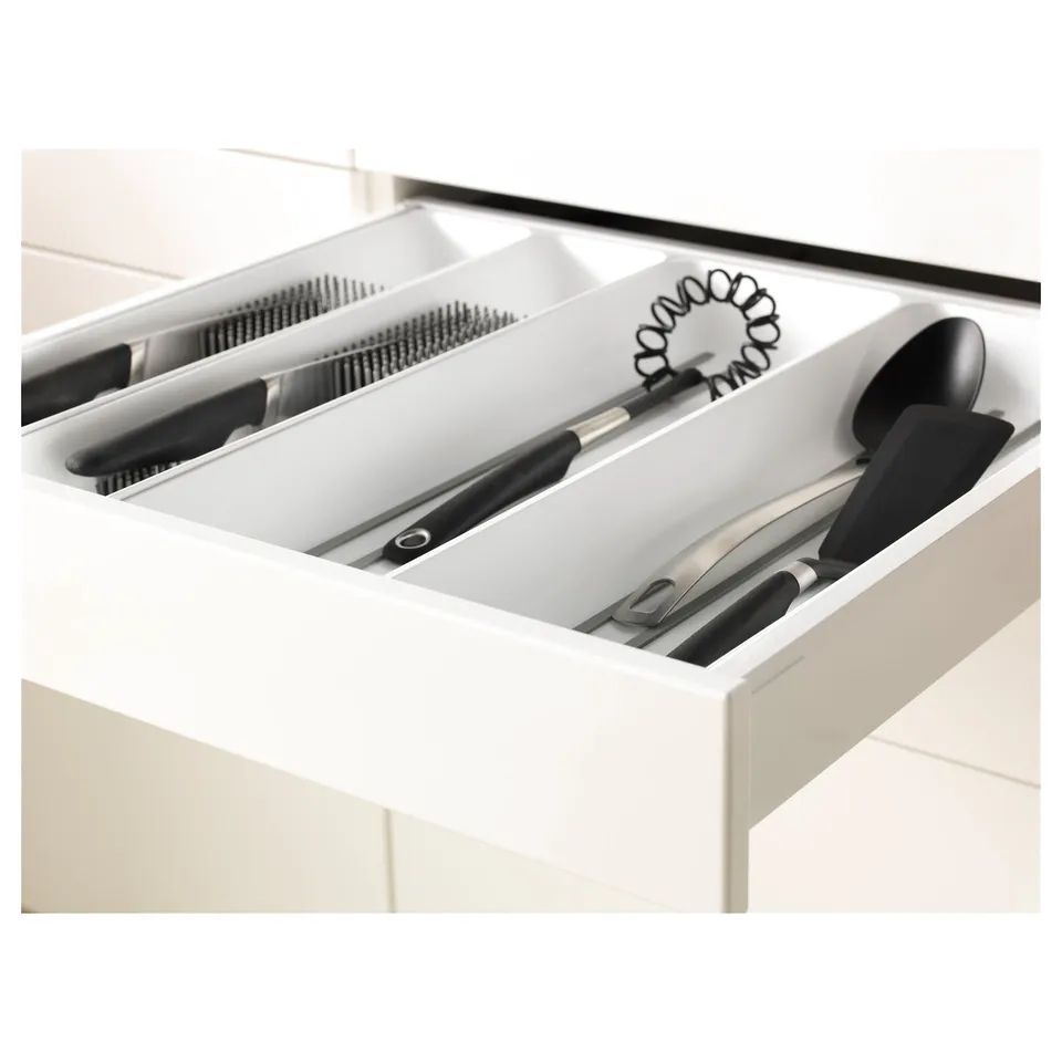 Kitchen drawer organiser with knives, spatulas, and utensils. Maximises storage space with compartments and smooth drawer.