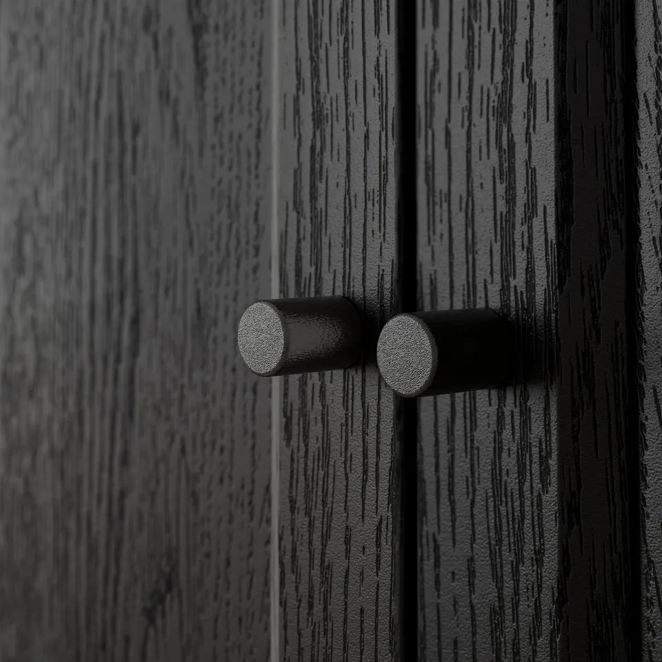 Black wooden doors with textured finish; two round, dark handles aligned horizontally.