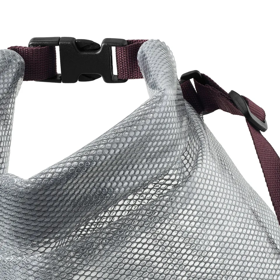 Displays a waterproof bag with sturdy buckles and a long carry strap. The grey textured material ensures durability.