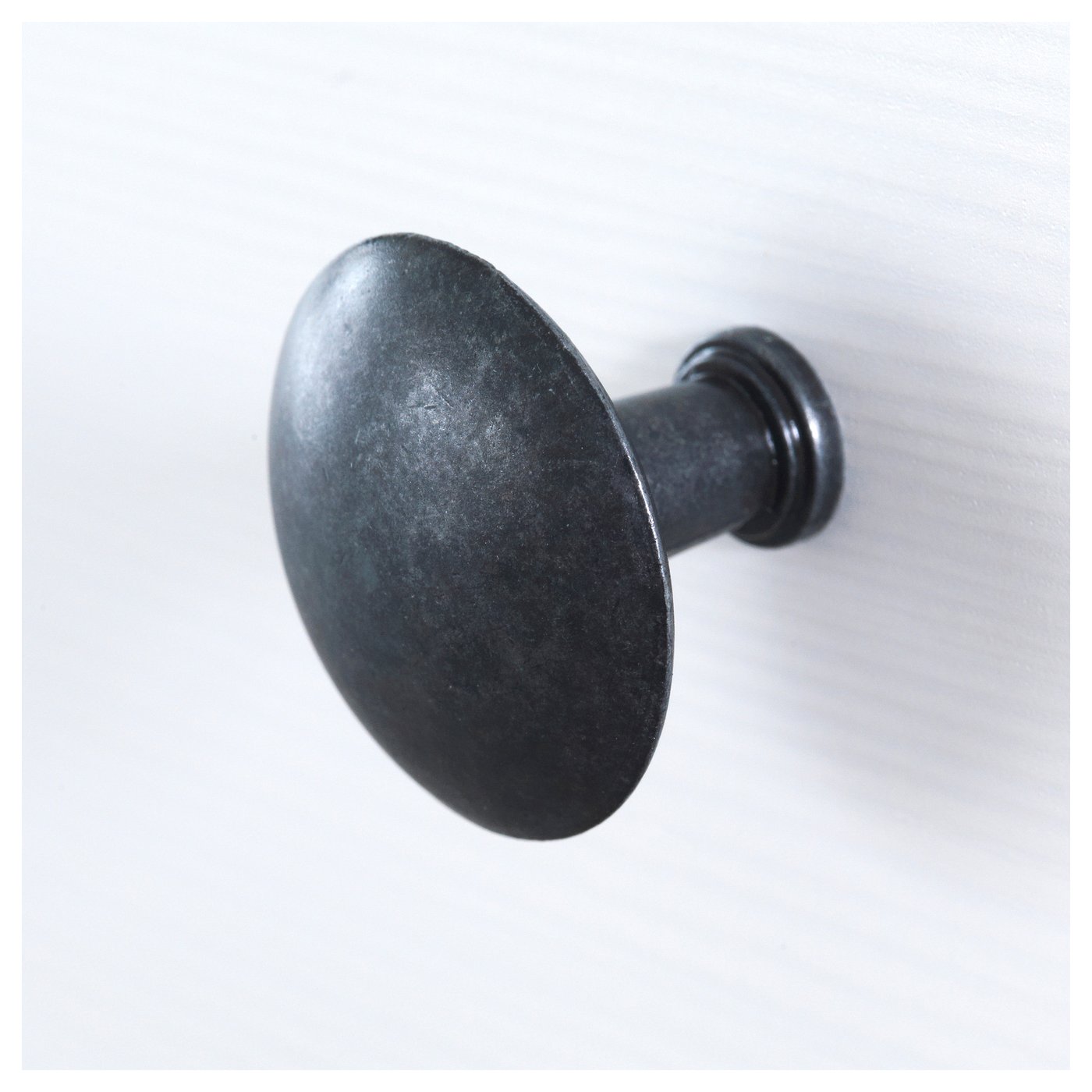 Dark, round wall-mounted hook; smooth finish; firm metal construction.