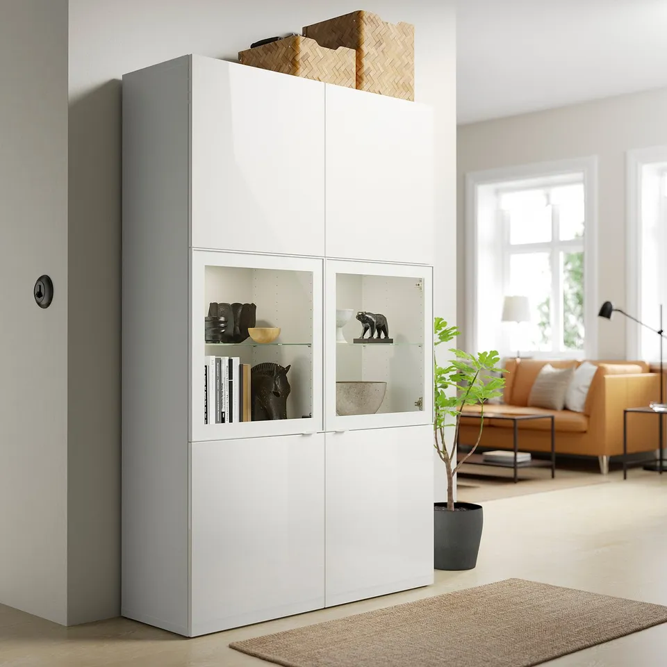 SELSVIKEN storage cabinet with glass doors, displaying decor.