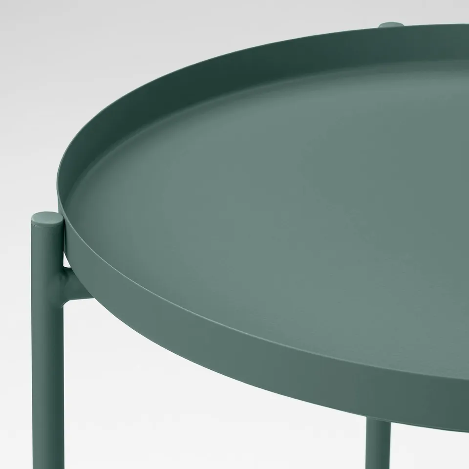 Small, green, round tray table with a smooth, durable surface. Expertly designed with easy-to-carry edges and stable, sturdy legs.