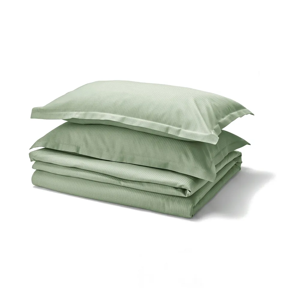 Green LÄKEVÄNDEROT bedding set, folded. Smooth, light, dobby-patterned with pillowcase flange.